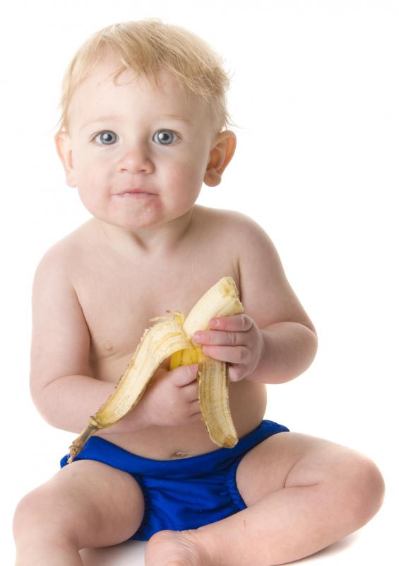 Baby eating a banana.
