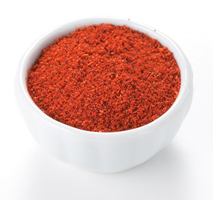 A bowl of paprika, which is typically made with ground pimiento.