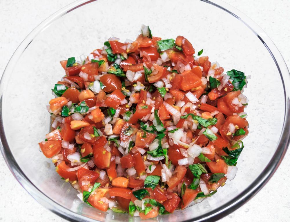One popular antipasto is chopped bruschetta salad with fresh tomatoes and basil.