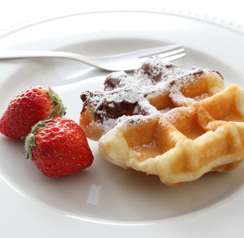 Waffles topped with powdered sugar.
