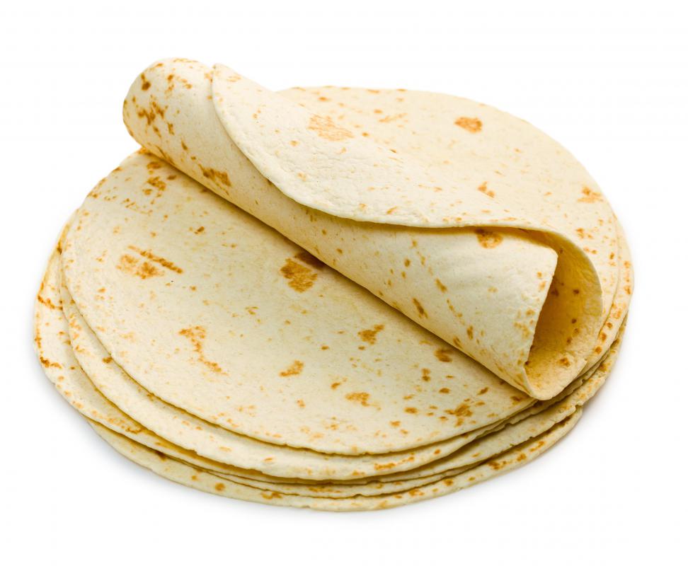 A simple burrito is made up of a flour tortilla filled with either beef, chicken, or pork.