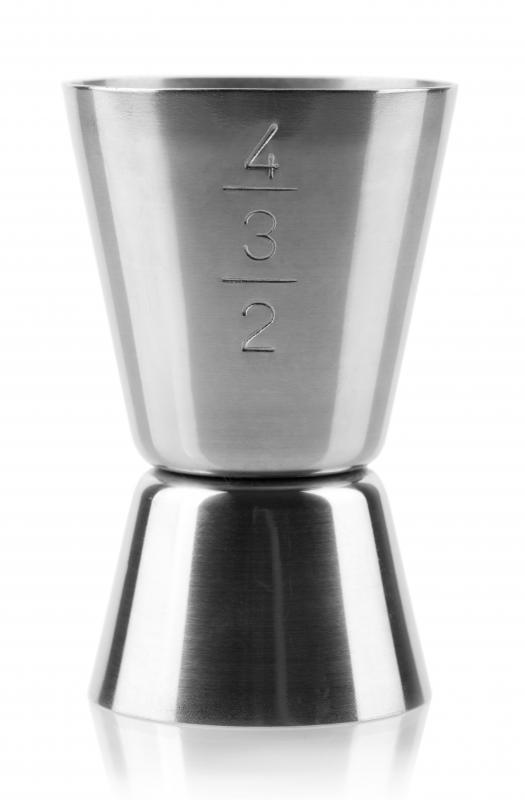 A jigger is used to measure alcohol to make a martini.