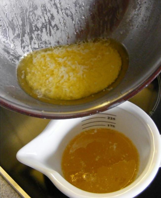 The leftover solids from making ghee, with a cup of ghee below.