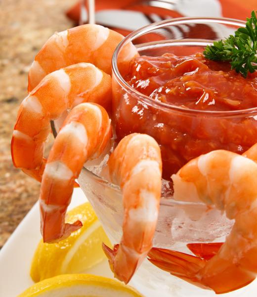 Cocktail sauce, usually made with red chili and tomatoes, is a key component of the shrimp cocktail.