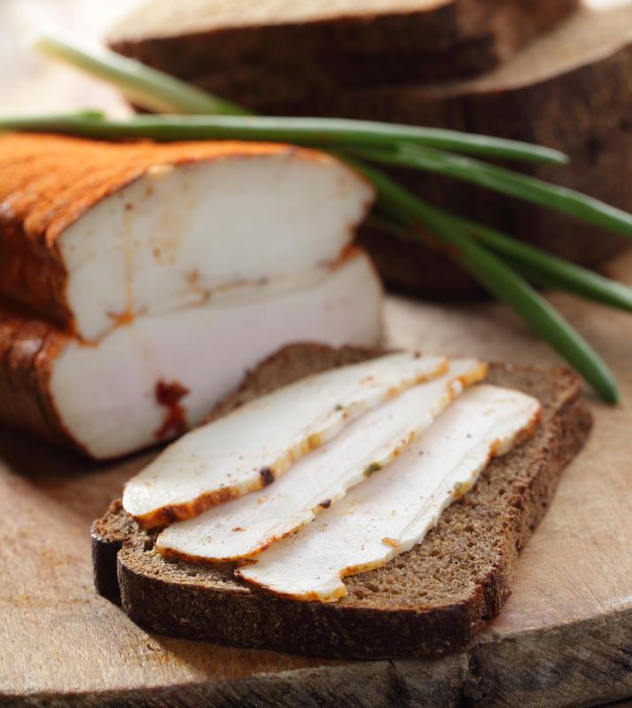 Thin slices of fatback on a piece of bread.