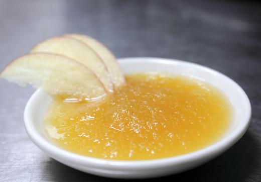 A potato masher can be used to crush cooked apples into applesauce.