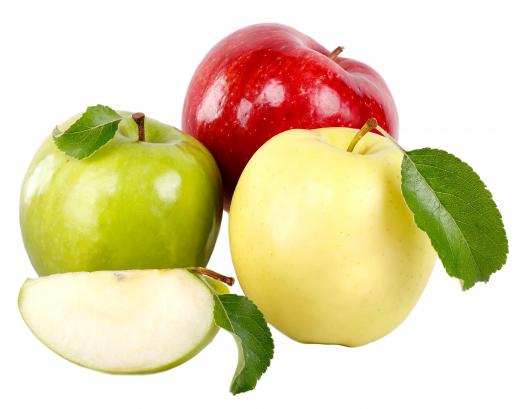 Three apples, including a golden delicious on the right.