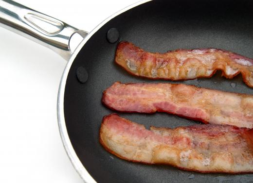 Bacon cooking in a frying pan.