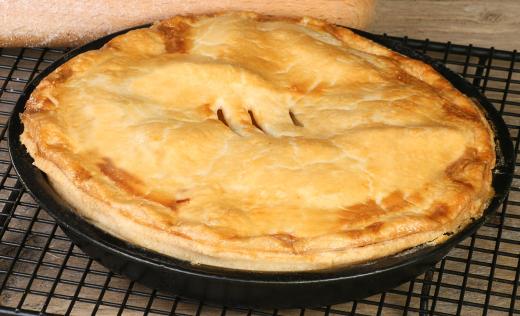 A person attending a potluck might bake a pie.