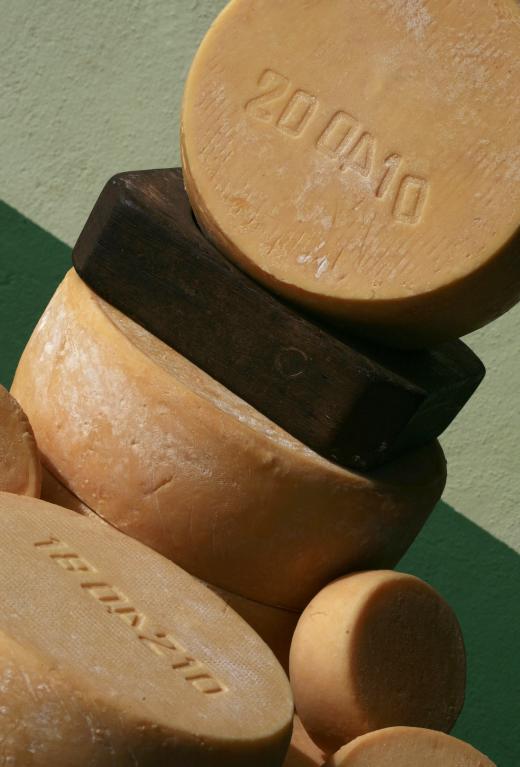 Cheese wheels are stamped with information about the product, such as when it was made.