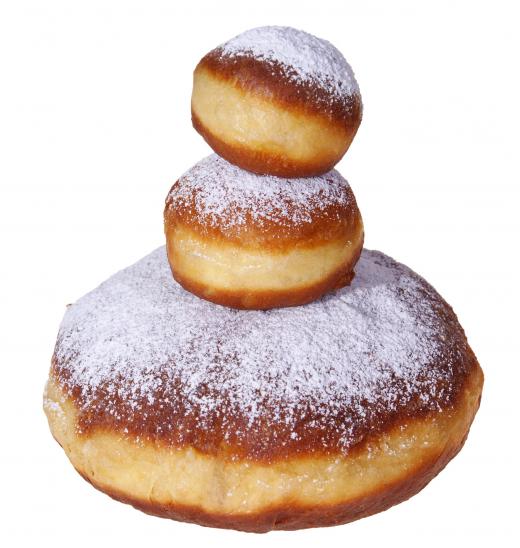 Donuts topped with confectioner's sugar, a type of white sugar.