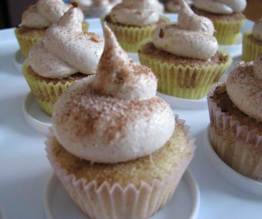 Snickerdoodle cupcakes may be displayed on a cupcake stand.