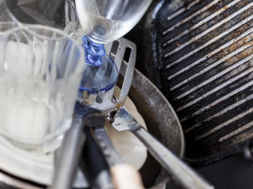 Dirty dishes should be scrubbed of stuck on food before washing.