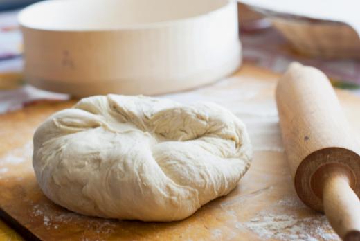 Bread dough is placed inside a cloche for baking.