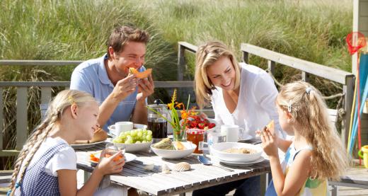 A picnic basket carries food, utensils and beverages to an outdoor meal.