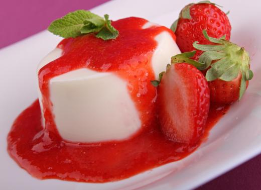 Strawberry coulis pooled around a dessert.