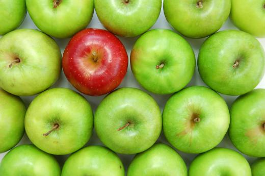 Granny Smith apples with one red apple.