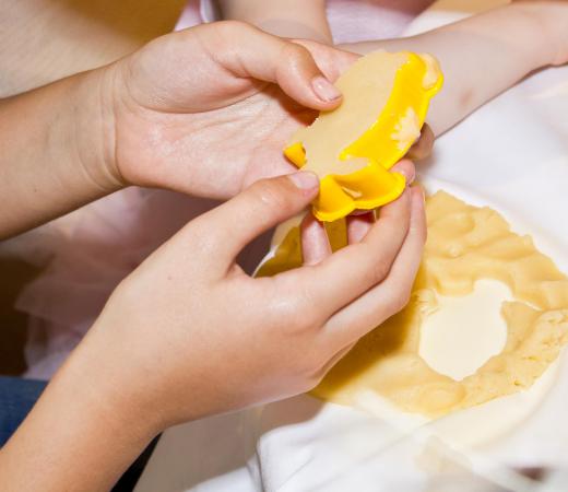 Icebox cookie dough may be rolled out into a flat sheet and cut into shapes using cookie cutters.