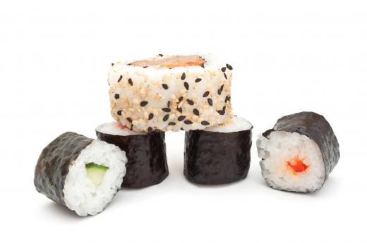 Hosomaki rolls underneath an uramaki roll.