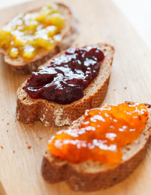 Toasted bread can be spread with jam, brie, or both.