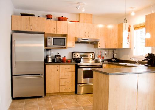 Kitchen with a blender, food processor, espresso machine, kettle, and toaster.