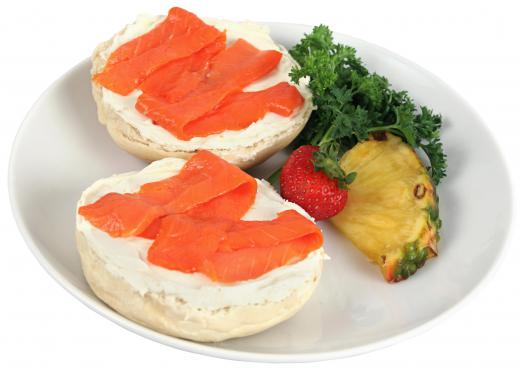 Lox is commonly served with cream cheese on a bagel.