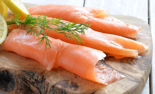 Lox, a thin filet of cured, cold smoked salmon, is commonly served with a schmear.