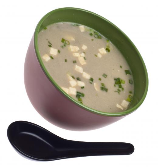 Miso soup consists of a thin broth and cooked tofu.