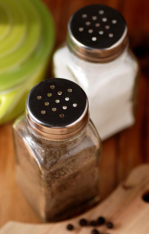 The process of seasoning flour begins with adding salt and pepper.