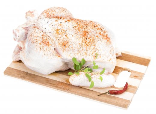 Rub a whole chicken with lemon pepper and other spices before roasting it.