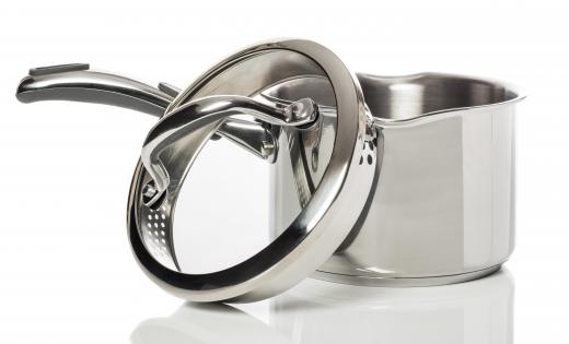 A stainless steel saucepan with a tempered glass lid.