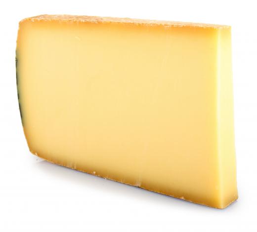 Thick slice of Gruyere cheese.