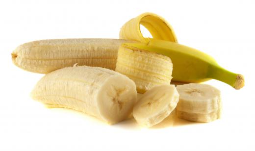 A peeled and sliced banana is the center piece of a banana split.