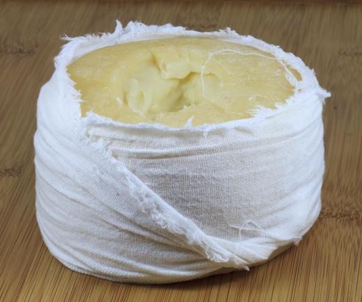 Spreadable cheese in cheesecloth.