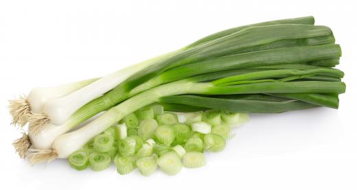 Spring onions have long green leaves at one end and a white bulb at the other.