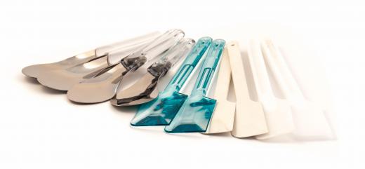 Kitchen supply stores often carry a variety of narrow spatulas.