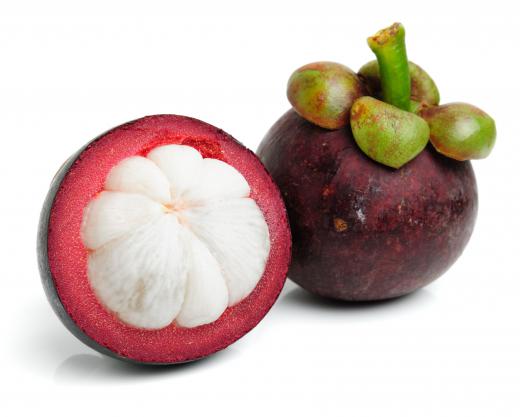 Whole and cut mangosteen.