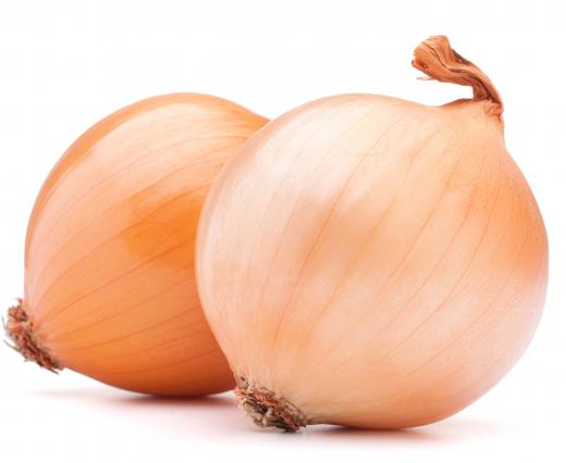 The first step in making an onion loaf is to cut onions into rings.