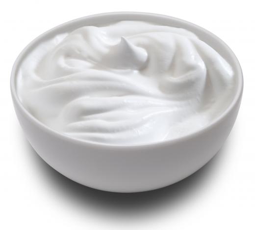 A bowl of sour cream, which is often served alongside antojitos.